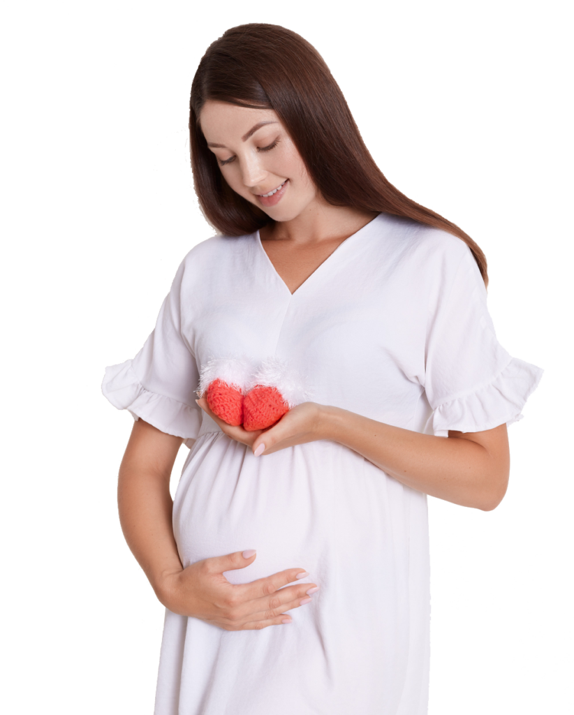 pregnant-happy-woman-holding-red-knitted-baby-shoes-her-hands-touching-her-belly-with-charming-smile